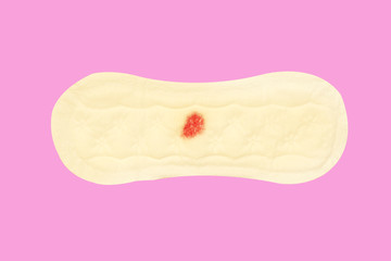 Slim sanitary napkin pad on female for menstrual period day use on every month on pink background. Clipping path.