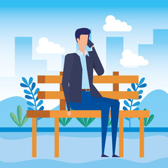 elegant businessman calling with smartphone seated in the park chair