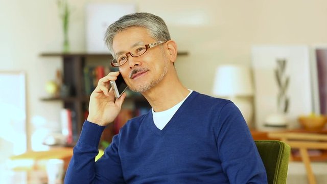 View of senior man using mobile phone, Osaka Prefecture, Japan - Powered by Adobe