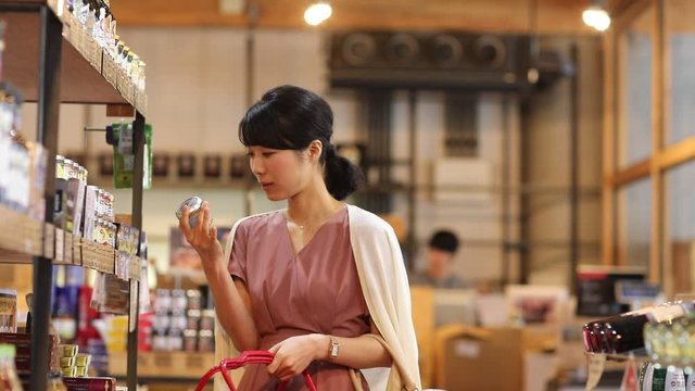 Panning shot of young woman shopping