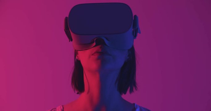 Woman in VR headset looking around. Cinematic 4K footage.