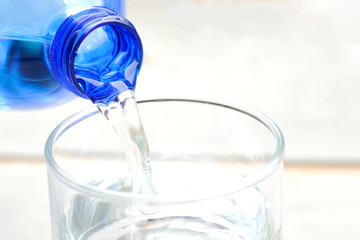 Clean water for good health. Pouring Fresh Pure Water From Pitcher Into A Glass on table wooden. Health And Diet Concept. Lifestyle Healthcare And Beauty.