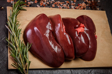 top view closeup group of raw pork kidneys with rosemary