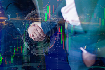 Double exposure businessmen shaking hands on abstract city and forex chart background.