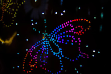 A butterfly formed by LED lights and the Bokeh effect in various colors.