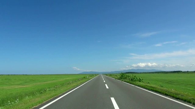 POV shot of empty road between fields, Sarumo, Hokkaido