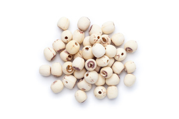 Pile of dried lotus seeds isolated on white background. Top view.