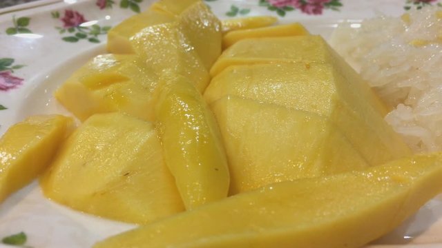Fresh yellow mango background, rotates, close up