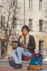 Lady girl happy smiles, sits skateboard.