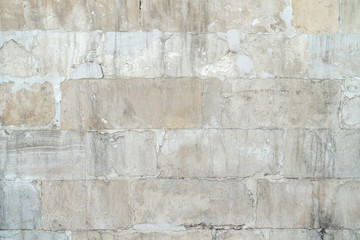 Fototapeta premium background old gray stone wall polished. repaired seams between stones. Rectangular concrete blocks. Copy space.