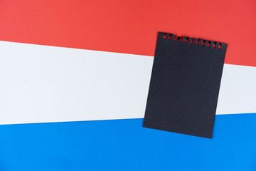 Blacklist Holland. Mourning, ban, sanctions, politics. black sheet of notebook lies on holland...
