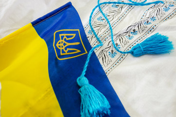 Ukrainian flag on the background of embroidered shirt, close-up