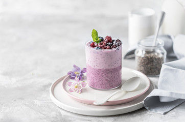 Homemade granola with nuts, chia seeds and fruit in a breakfast mug. Light photo
