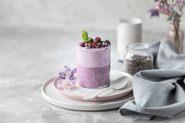 Homemade granola with nuts, chia seeds and fruit in a breakfast mug. Light photo