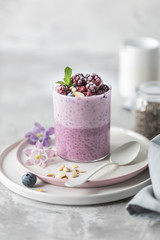 Homemade granola with nuts, chia seeds and fruit in a breakfast mug. Light photo