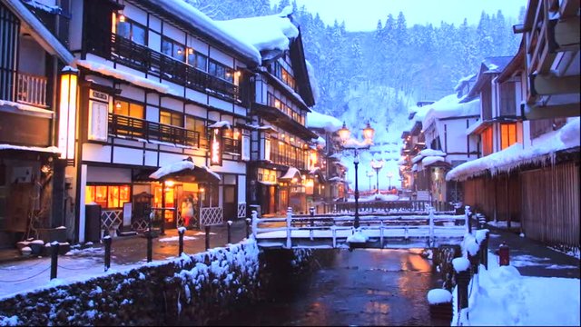 River flowing through&nbsp;snow covered&nbsp;town at dusk