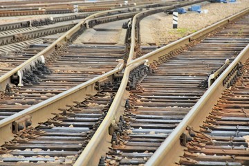 Railroad rails at a small station, fork, arrows, mechanical elements.