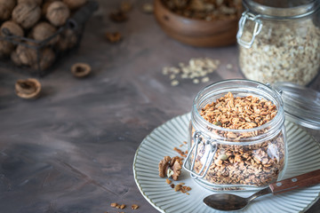 Homemade granola with nuts and seeds in glass jar for healthy breakfast