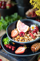 Homemade pumpkin muesli with nuts and seeds in a glass jar for a healthy breakfast. Autumn still life. Dark photo