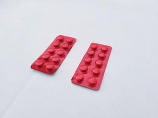 red medicine tablet isolated on white background