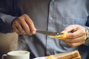 Business man eat the American breakfast set in a hotel - people take a breakfast in hotel concept