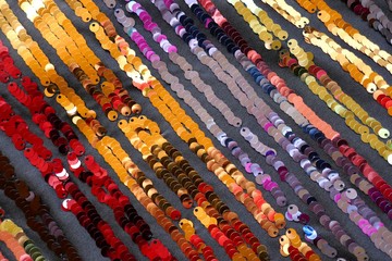 sequin striped pattern.Multicolored stripes from sequins on a gray background.Shimmering .Seamless...