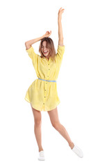 Beautiful young woman in yellow dress dancing on white background