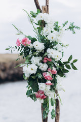 Fragment of a wedding arch for an exit ceremony decorated with white and pink flowers.