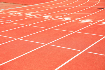 Start of red athletic track with numbers. Sport concept