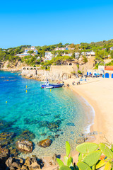 CALELLA DE PALAFRUGELL, SPAIN - JUN 2, 2019: Divers walking to boat on picturesque beach in Calella...