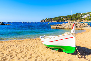 Traditional fishing boat on beach in Port Bo, old town of Calella de Palafrugell village, Costa Brava, Spain