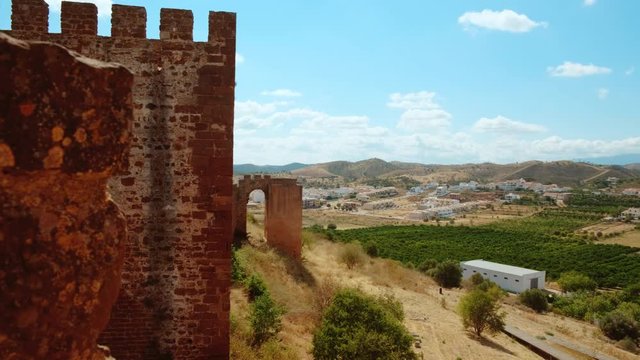 Establishing view of the Castle of Silves, with roots dating back to 201 BC and scenic Silves town in the Algarve, Portugal