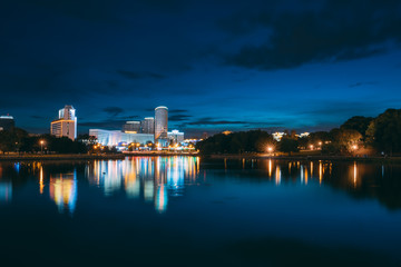 Minsk, Belarus. Residential House Near Trinity Hill Suburb, Svisloch River, Business Center Royal Plaza On Pobediteley Avenue. Summer Evening, Night Lights Illumination