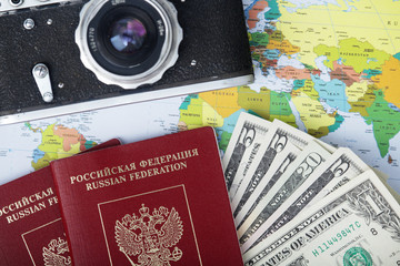 Fototapeta na wymiar A vintage camera, map and international passport as a traveling essentials