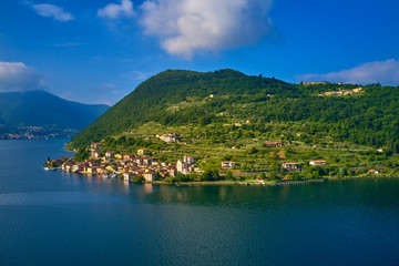 Fototapeta na wymiar Flying over the island of Monte on Lake Iseo north of Italy. Panoramic view of the alps. A good place to rest in travel.