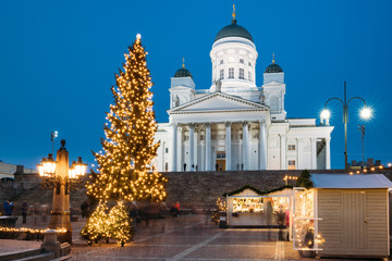 Obraz premium Helsinki, Finland. Christmas Xmas Holiday Carousel On Senate Square Near Famous Landmark. Lutheran Cathedral At Winter Evening