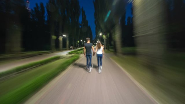 The couple walking in the evening park. Hyperlapse