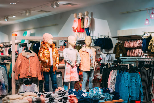 Mannequins Dressed In Children Female Casual Clothes And Colorful Bright Children Clothes On Shelves And Hanger In Store Of Shopping Center