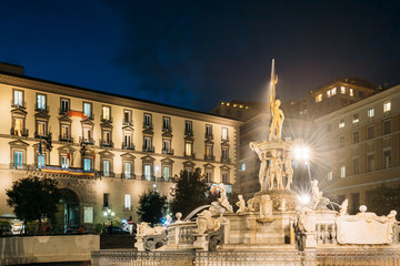 Obraz premium Naples, Italy. Fountain Of Neptune On Piazza Municipio In Evening Or Night Illuminations