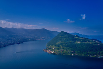 Flying over the island of Monte on Lake Iseo north of Italy. Panoramic view of the alps. A good place to rest in travel.