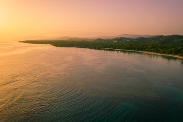 Fototapeta premium Drone shot of tropical beach at sunrise.Samana peninsula,Bahia Principe beach,Dominican Republic.