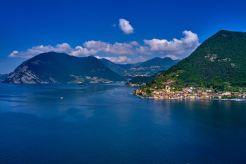 Flying over the island of Monte on Lake Iseo north of Italy. Panoramic view of the alps. A good place to rest in travel.