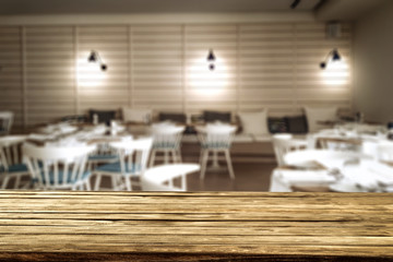 Wooden table background and restaurant interior view. Empty  space for your decoration and an advertising product.