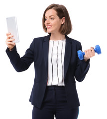 Young businesswoman with tablet PC and dumbbell on white background. Concept of balance between work and leisure