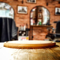 Wooden table background with blurred barber shop view. Empty space for decoration and advertising products.
