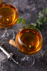 Two glasses with white wine on a textural background. Copy space. Place for your text.