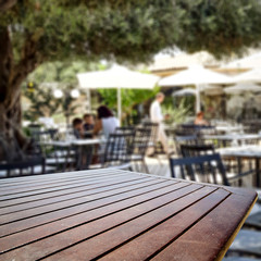 Table background  in a restaurant outdoor view. Empty  space for your decoration and an advertising product.