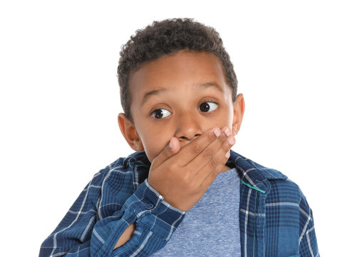 Surprised African-American boy on white background