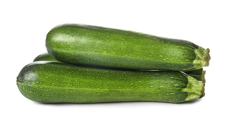 Fresh zucchini squashes on white background