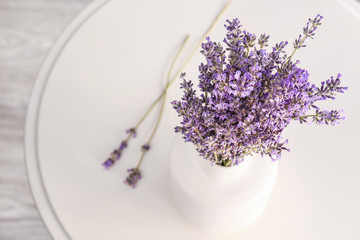 Beautiful lavender flowers in vase on table, closeup